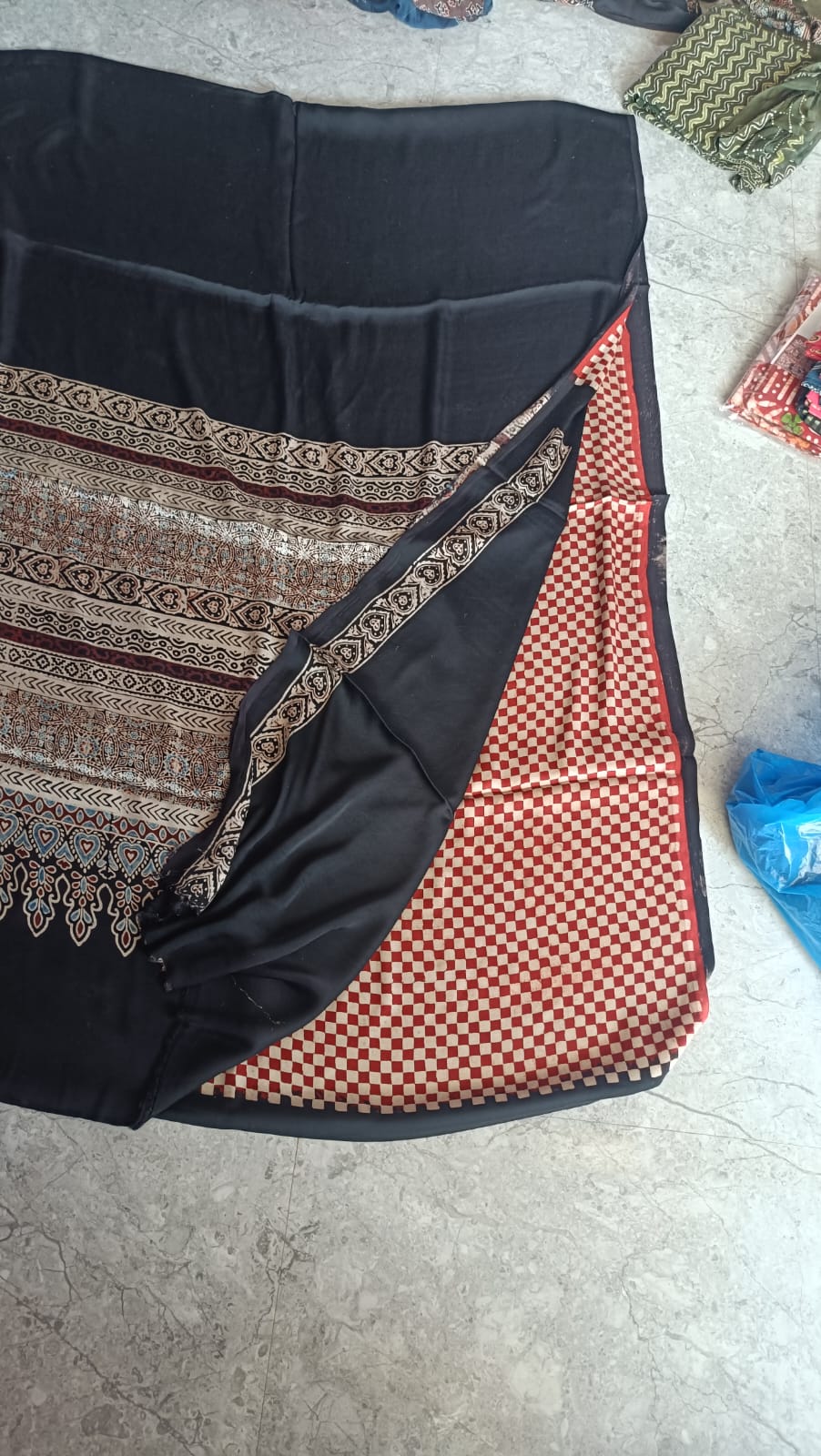 Ajrakh saree in rich earth tones with traditional dye patterns